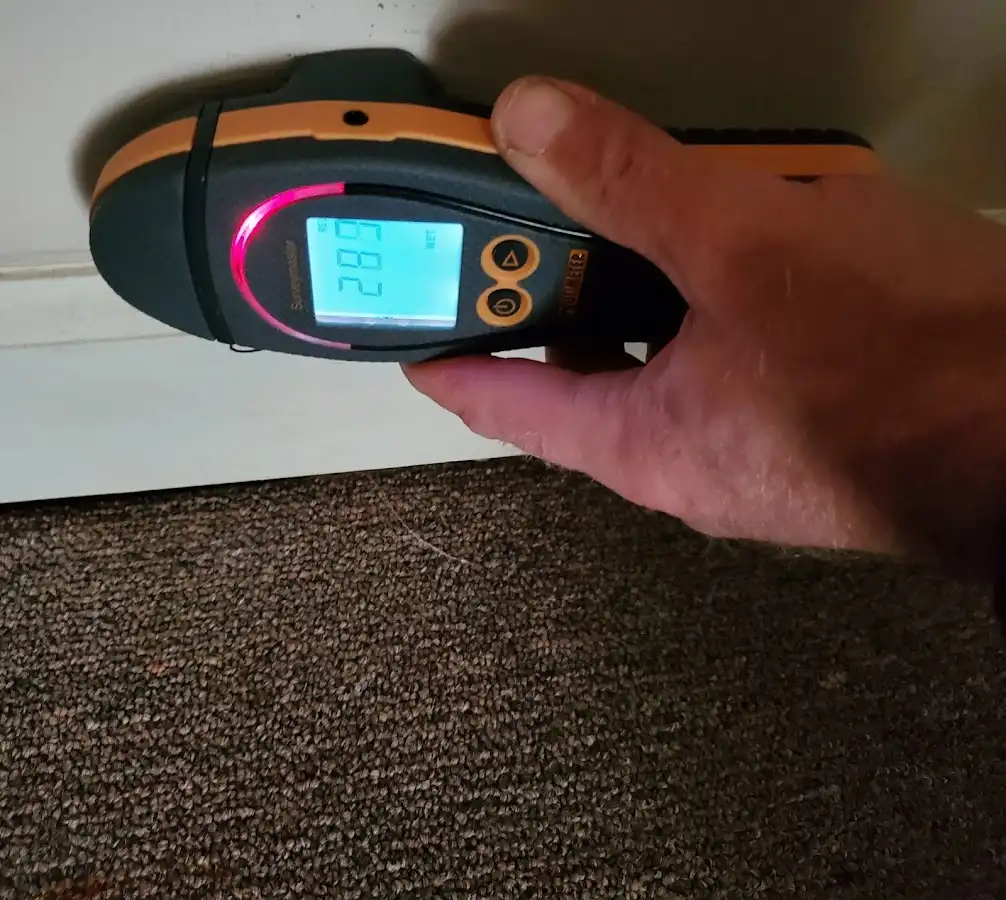 Moisture detection at baseboard during Storm Damage Restoration in Lighthouse Point